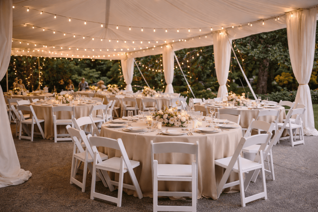 Interior view of a 20x40 event tent with lighting, draping, and seating arranged for a backyard wedding