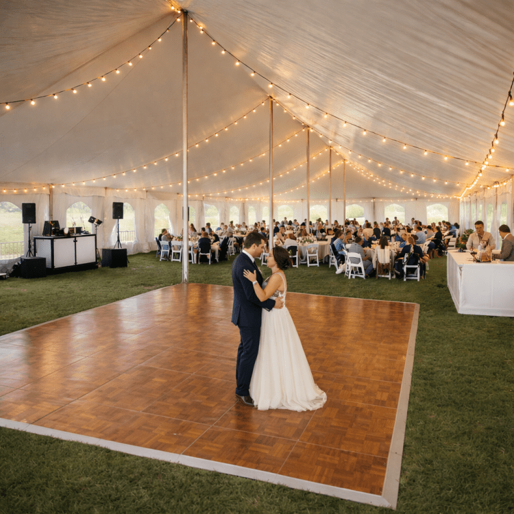 Wedding dance floor setup inside large event tent with lighting in Cranberry Township PA