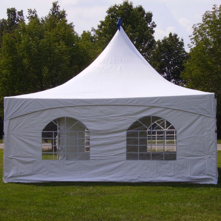 White pole tent with sidewalls installed on grass for outdoor event setup