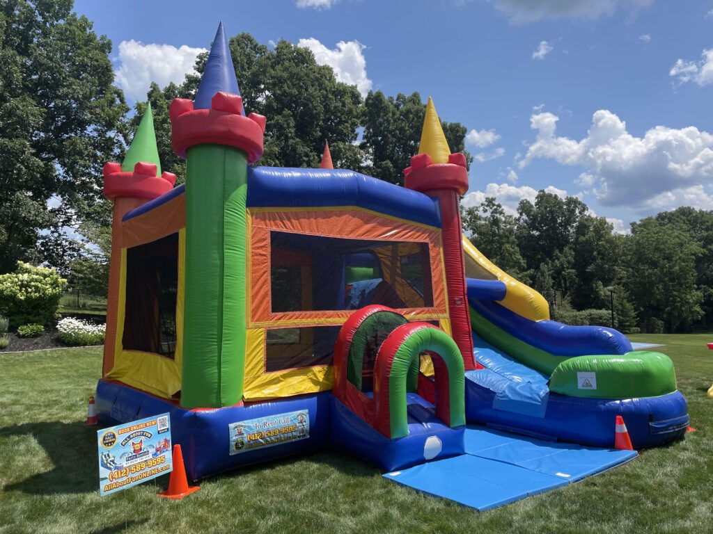 Colorful bounce house with slide for kids party rental in Butler PA