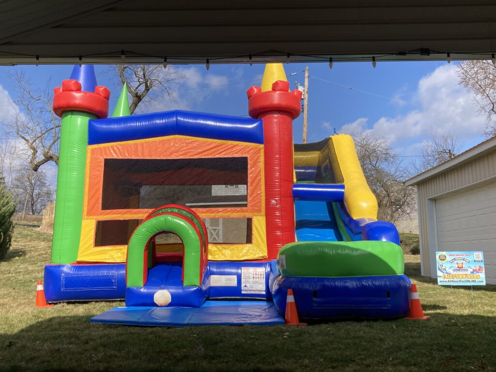Inflatable bounce house with slide setup for party rental in Butler PA