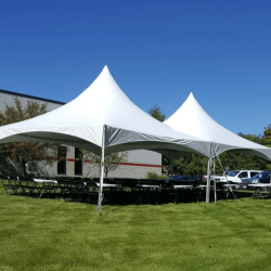 White event tent setup with tables and chairs for outdoor party rental