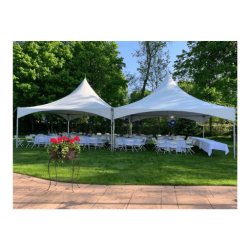 White high peak event tent with banquet tables and chairs set up outdoors