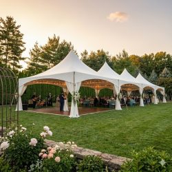 White event tent setup for an outdoor wedding and reception