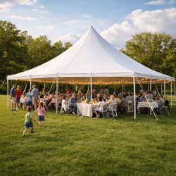 Outdoor wedding tent rental setup in Pittsburgh PA with string lights, round tables, and white folding chairs at evening reception